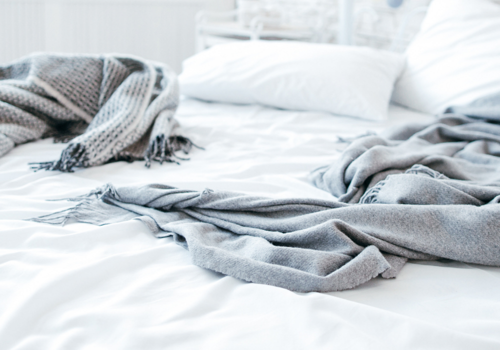 white bedding with grey blankets on top