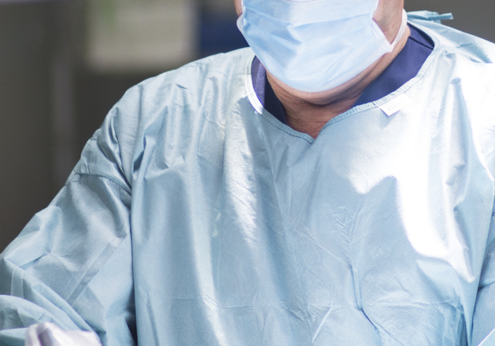 surgeon wearing surgical gown and mask