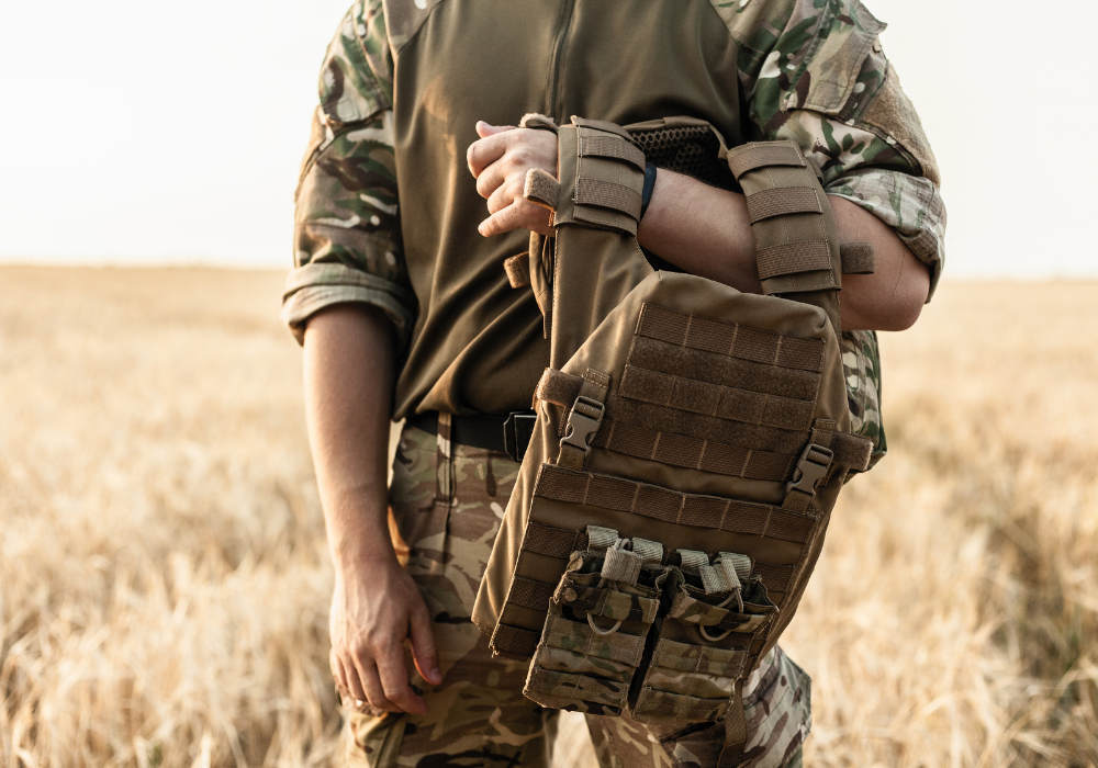 soldier stood in field with a backpack