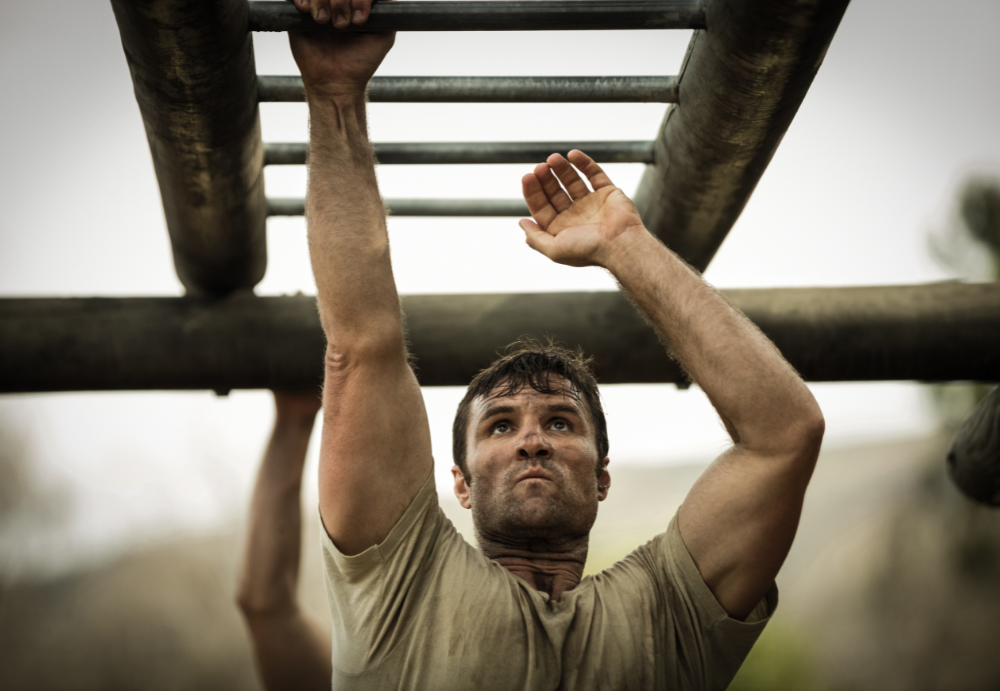 soldier doing a physical assessment on monkey bars