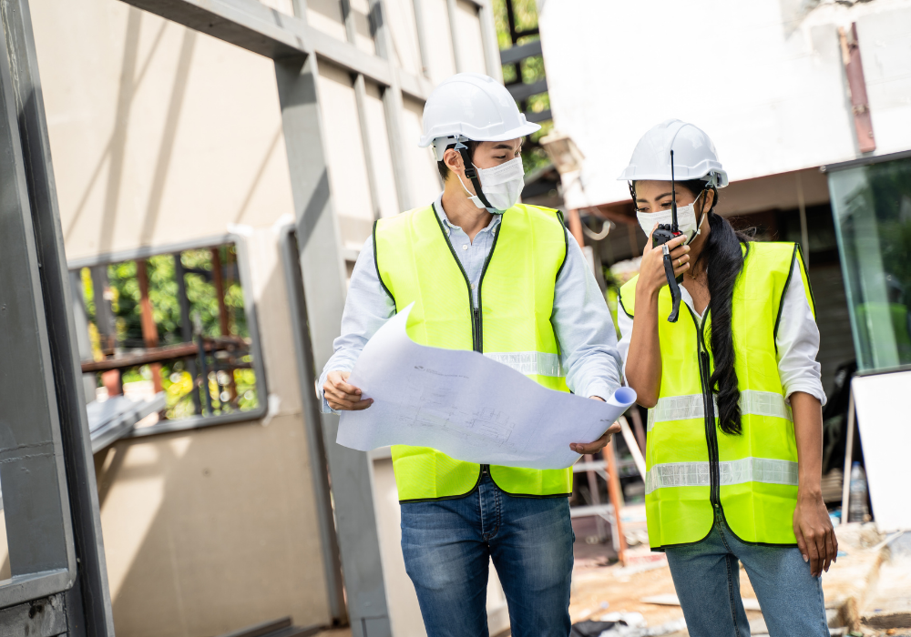 construction site workers with hard hats and high visibility vests