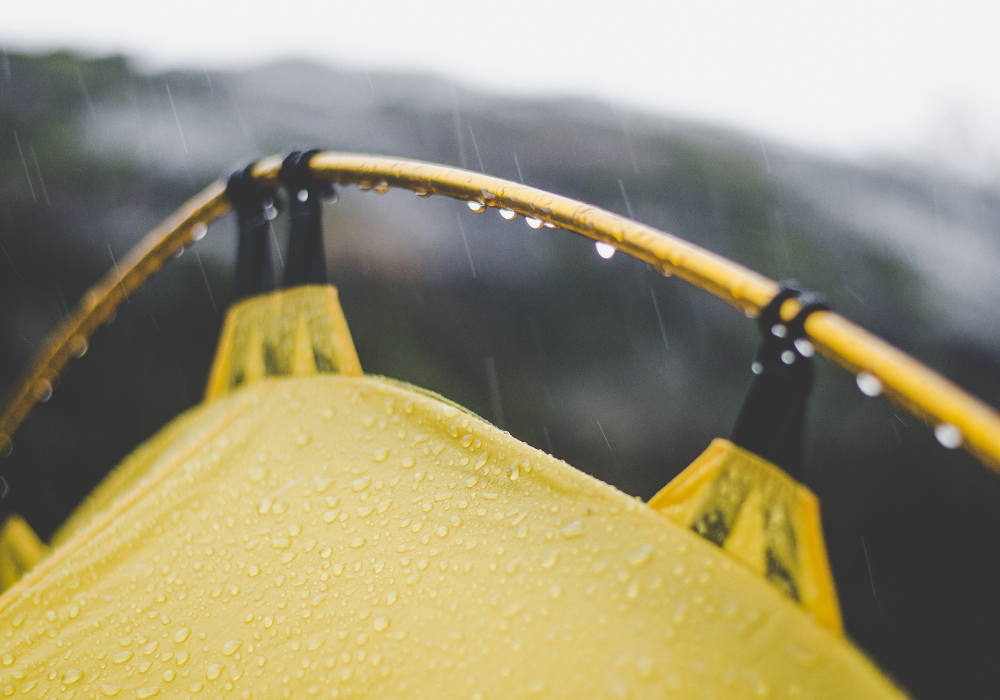 top of a yellow tent in pouring rain