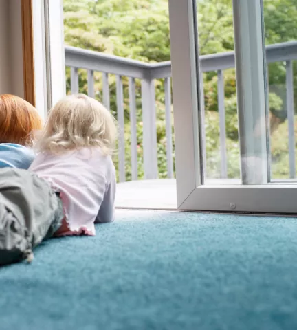 Children By Window On Carpet