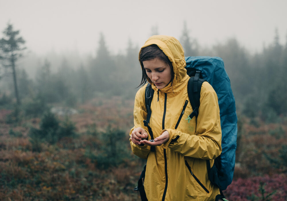 Woman in rain in yellow jacket - application for testing in AquAbrasion