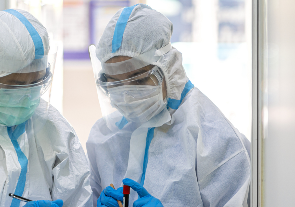 Two hospital workers wearing personal protective equipment ppe