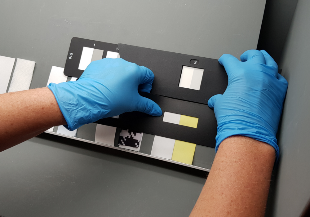 phenolic yellowing samples being graded in a light box